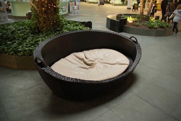 Large round padded basket-like seat with a white cushion.