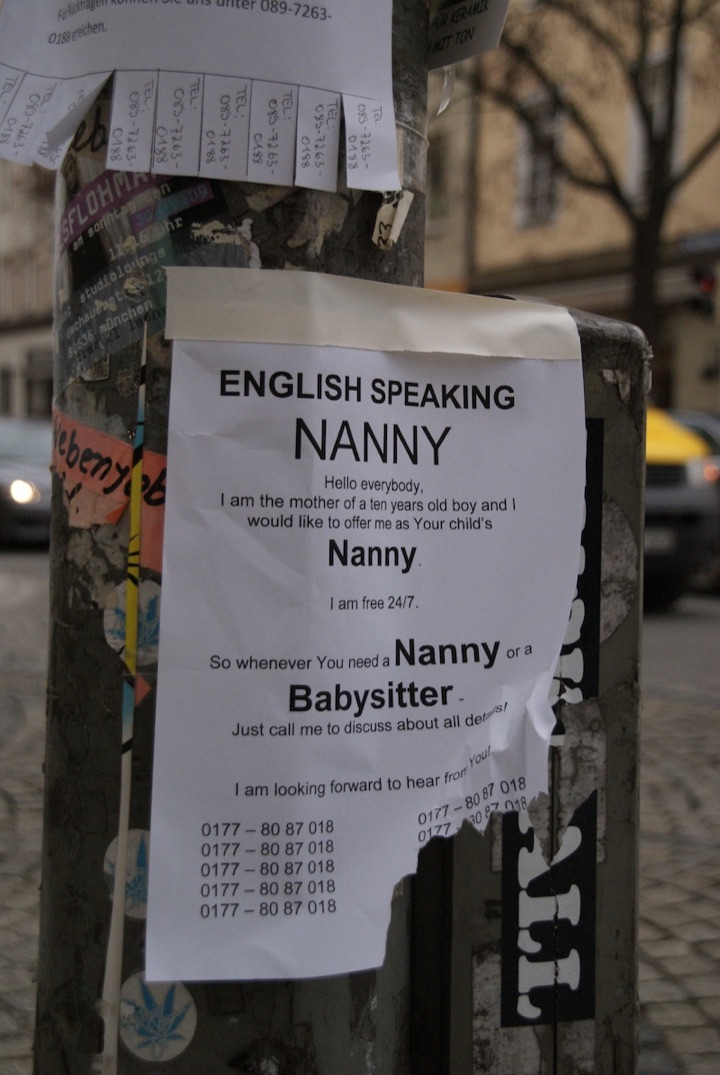 Two paper notices on a street pole, using different layouts for tear-off phone-number tabs.