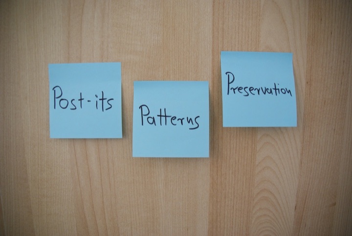Three blue sticky notes labeled “Post-its,” “Patterns,” and “Preservation” on a wood panel.