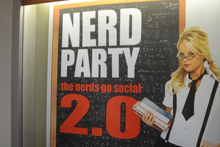 Poster reading “NERD PARTY the nerds go social 2.0” with a woman holding books.